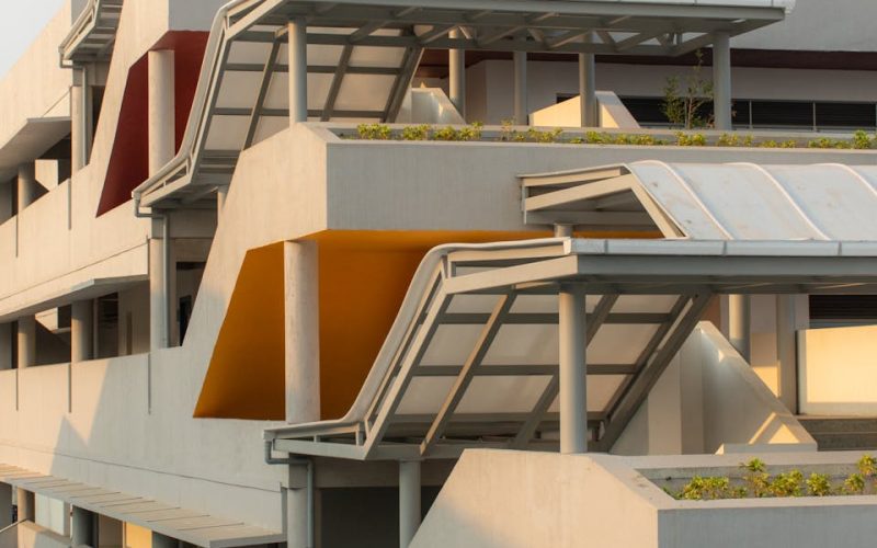 Modern building exterior featuring geometric shapes and colorful accents in an urban setting.