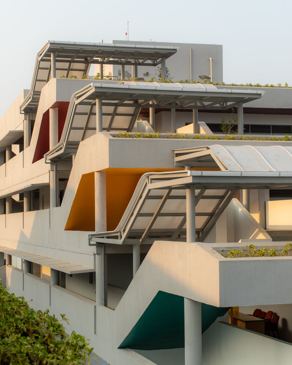 Modern building exterior featuring geometric shapes and colorful accents in an urban setting.