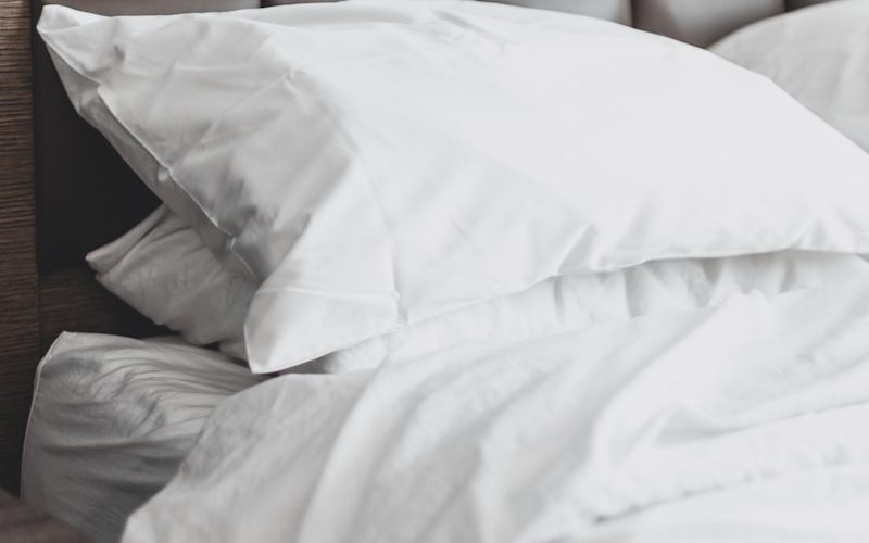 white bed pillow on bed